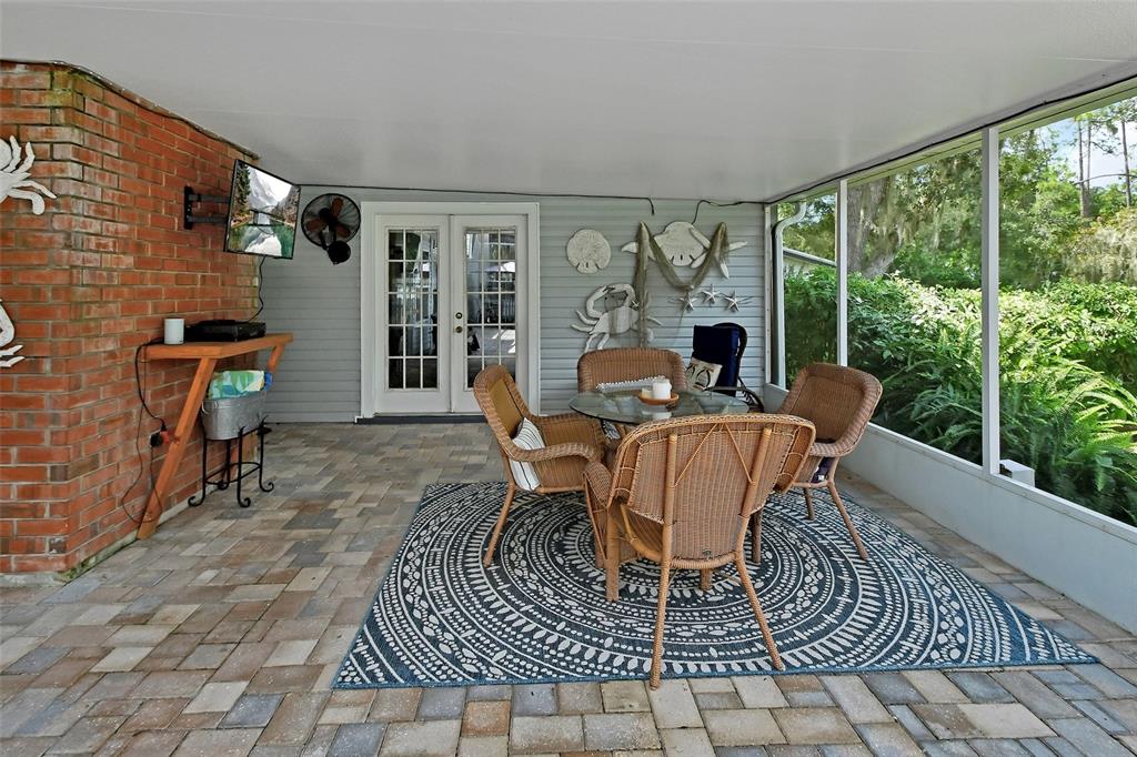 2236 River Ridge Road DeLand, FL 32720 - Photo 6 of 84 a dining room with furniture a rug and wooden floor
