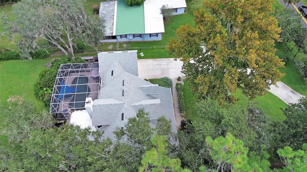2236 River Ridge Road DeLand, FL 32720 - Photo 75 of 84 an aerial view of a house with a yard and trees all around