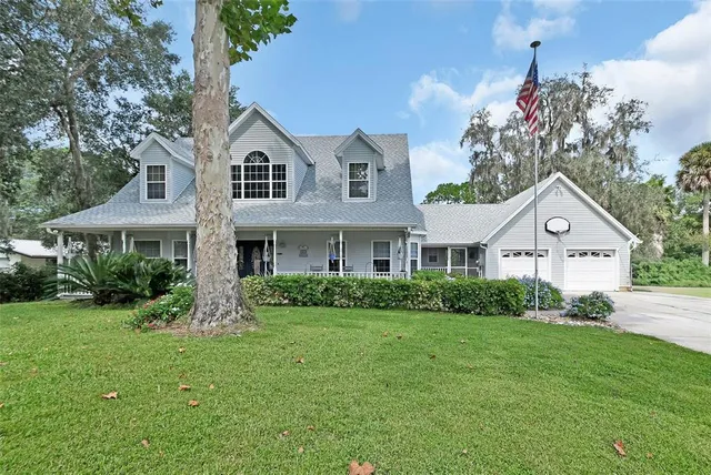 a kitchen with stainless steel appliances a dining table chairs stove and refrigerator