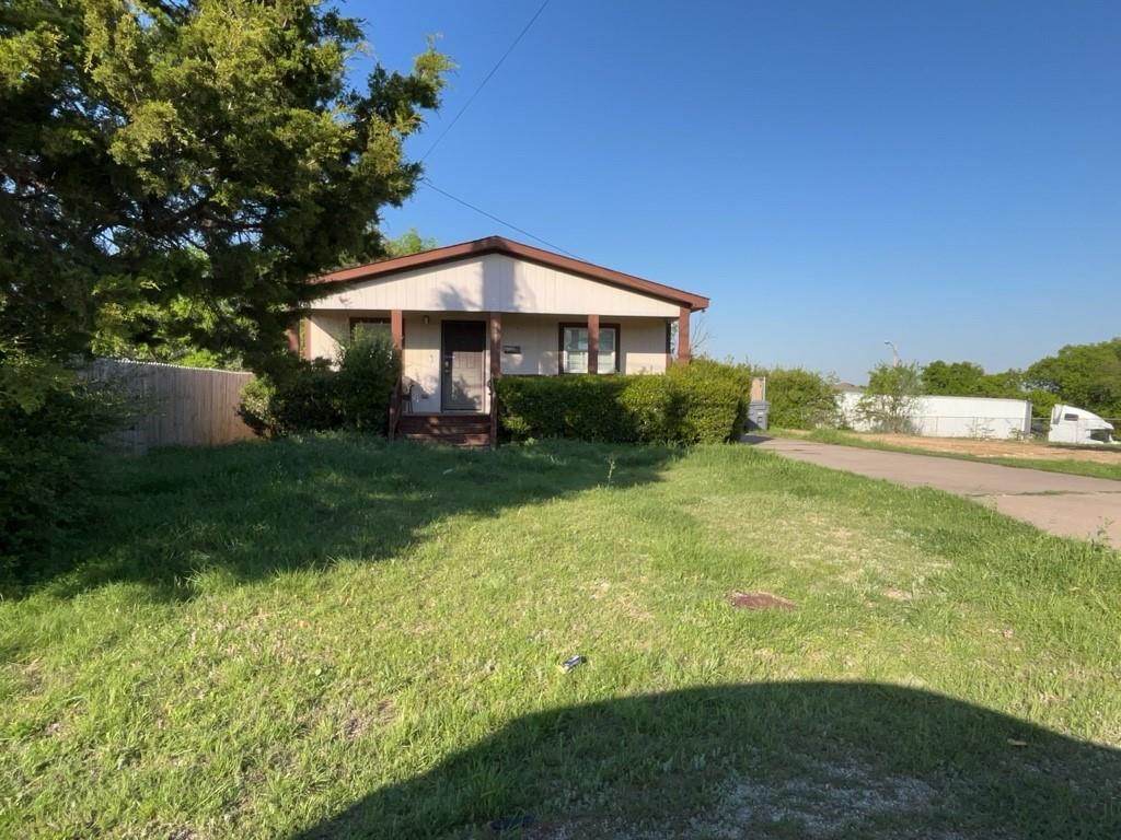 a view of a garden with a bench under an umbrella