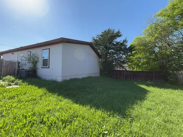 a backyard of a house with lots of green space
