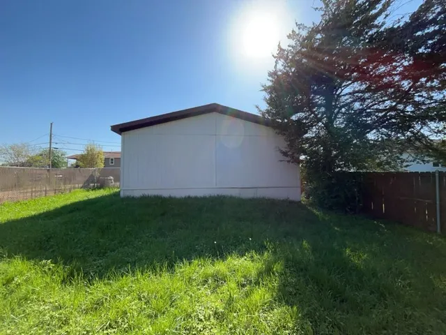 a backyard of a house with lots of green space