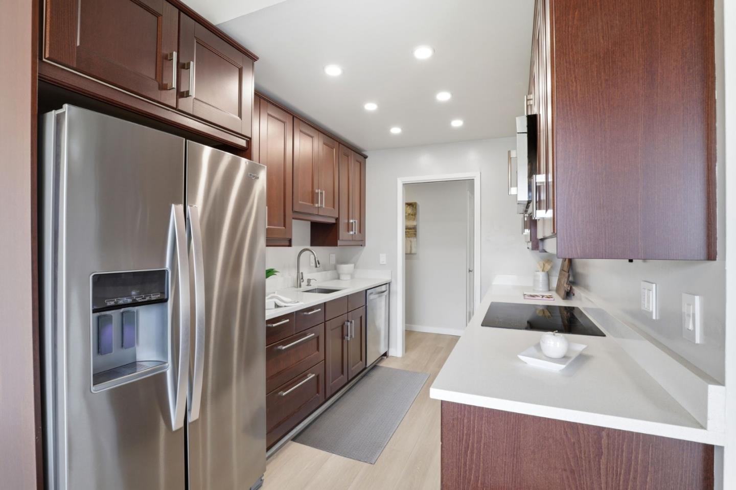 255 South Rengstorff Avenue, Unit 2 Mountain View, CA 94040 - Photo 7 of 25 a kitchen with stainless steel appliances granite countertop a refrigerator a sink and a stove