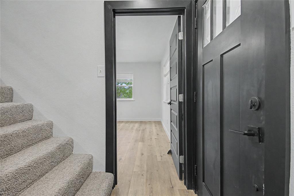 502 Rogers Way Rockwall, TX 75087 - Photo 12 of 23 a view of a hallway with furniture and a livingroom with wooden floor