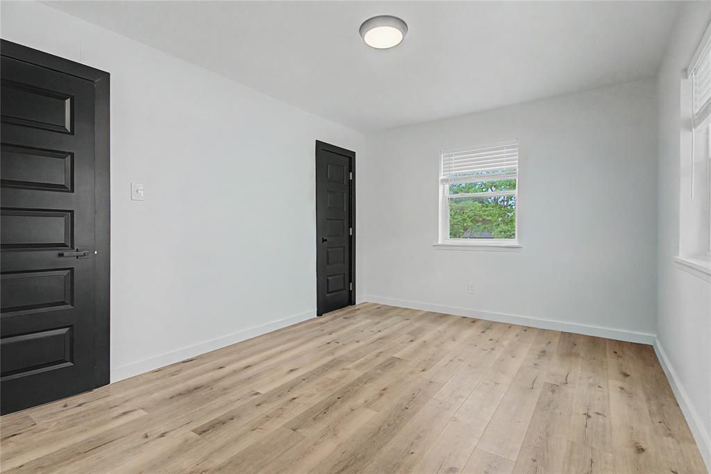 502 Rogers Way Rockwall, TX 75087 - Photo 13 of 23 an empty room with wooden floor and windows