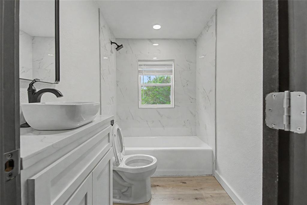 502 Rogers Way Rockwall, TX 75087 - Photo 16 of 23 a bathroom with a granite countertop sink toilet and shower