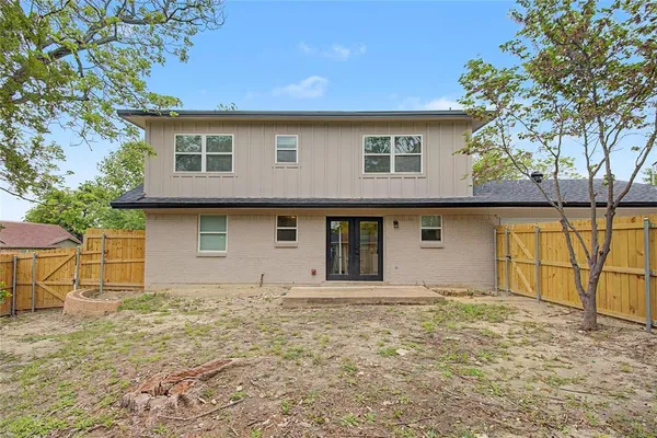 a front view of house with yard and trees