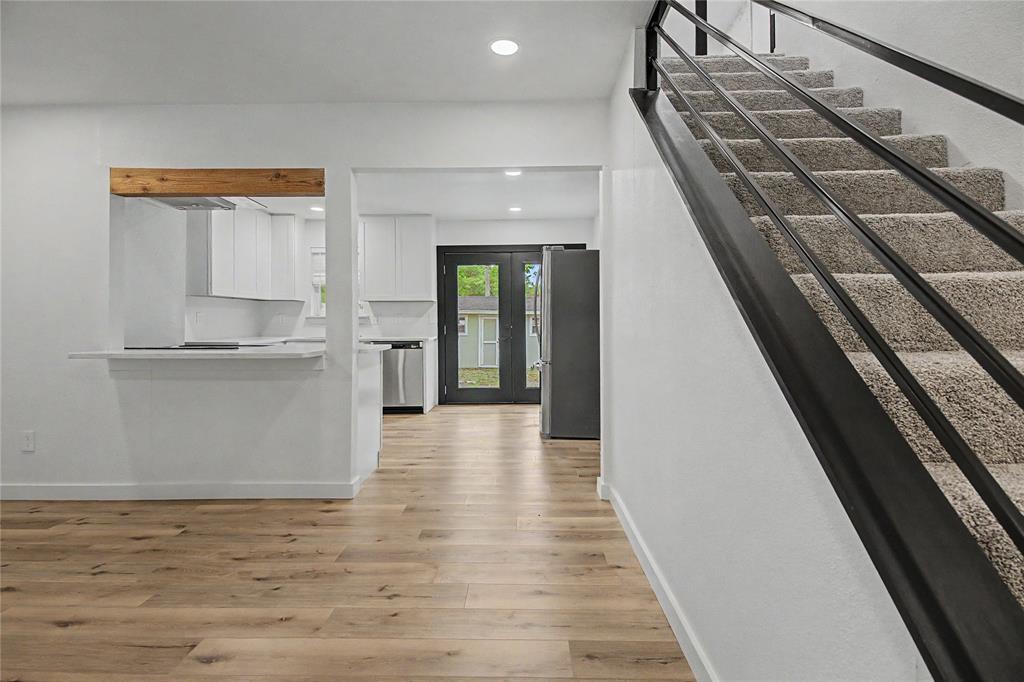 502 Rogers Way Rockwall, TX 75087 - Photo 3 of 23 a view of a hallway with wooden floor and staircase