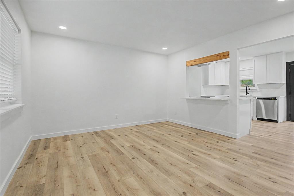 502 Rogers Way Rockwall, TX 75087 - Photo 4 of 23 a view of empty room with wooden floor and kitchen