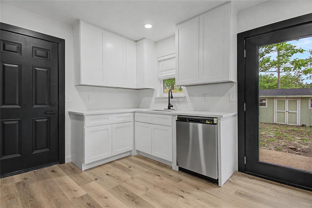 502 Rogers Way Rockwall, TX 75087 - Photo 7 of 23 a kitchen with a sink cabinets and wooden floor