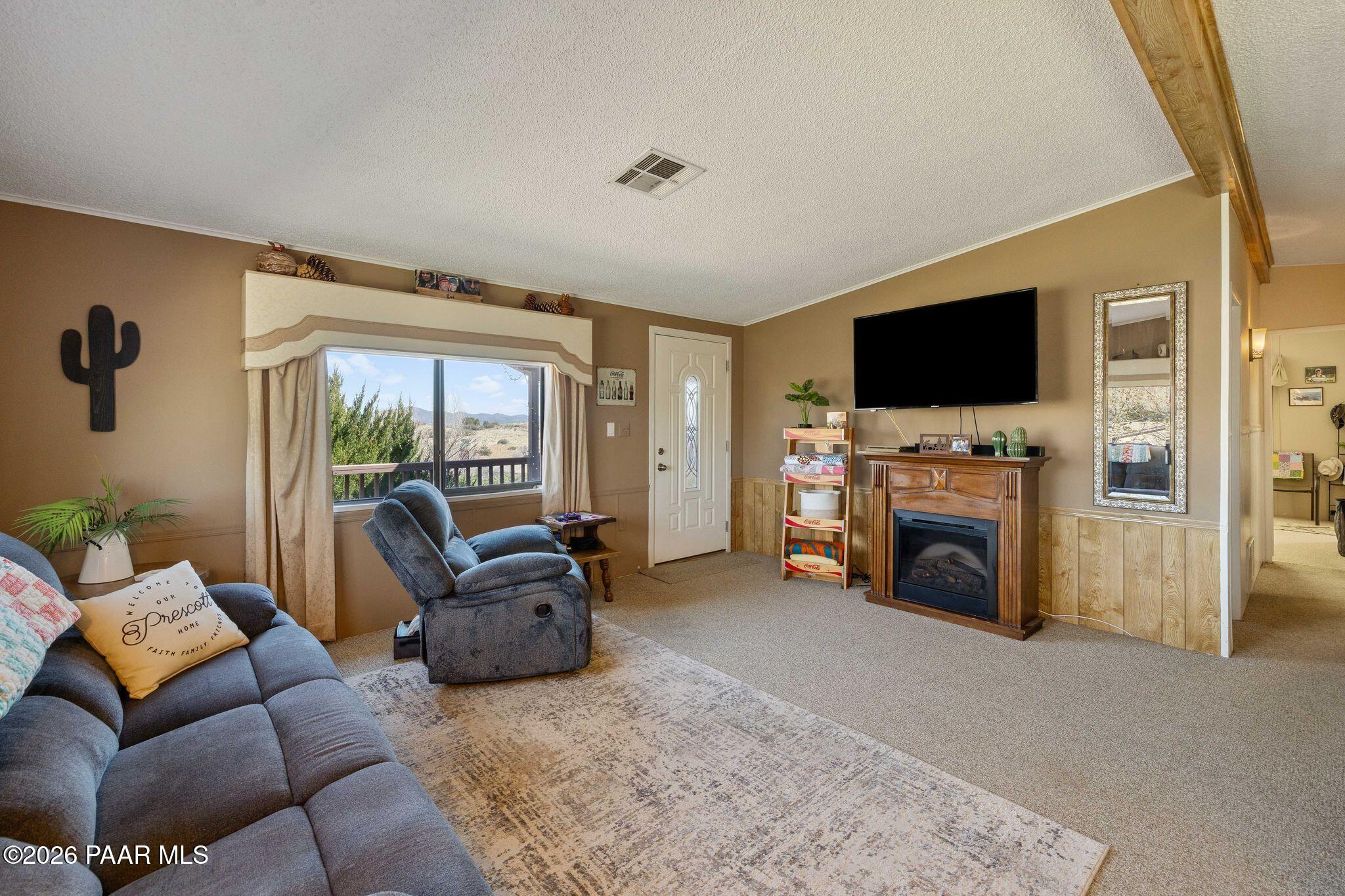 10194 East Durham Road Dewey, AZ 86327 - Photo 12 of 47 a living room with furniture a fireplace and a flat screen tv