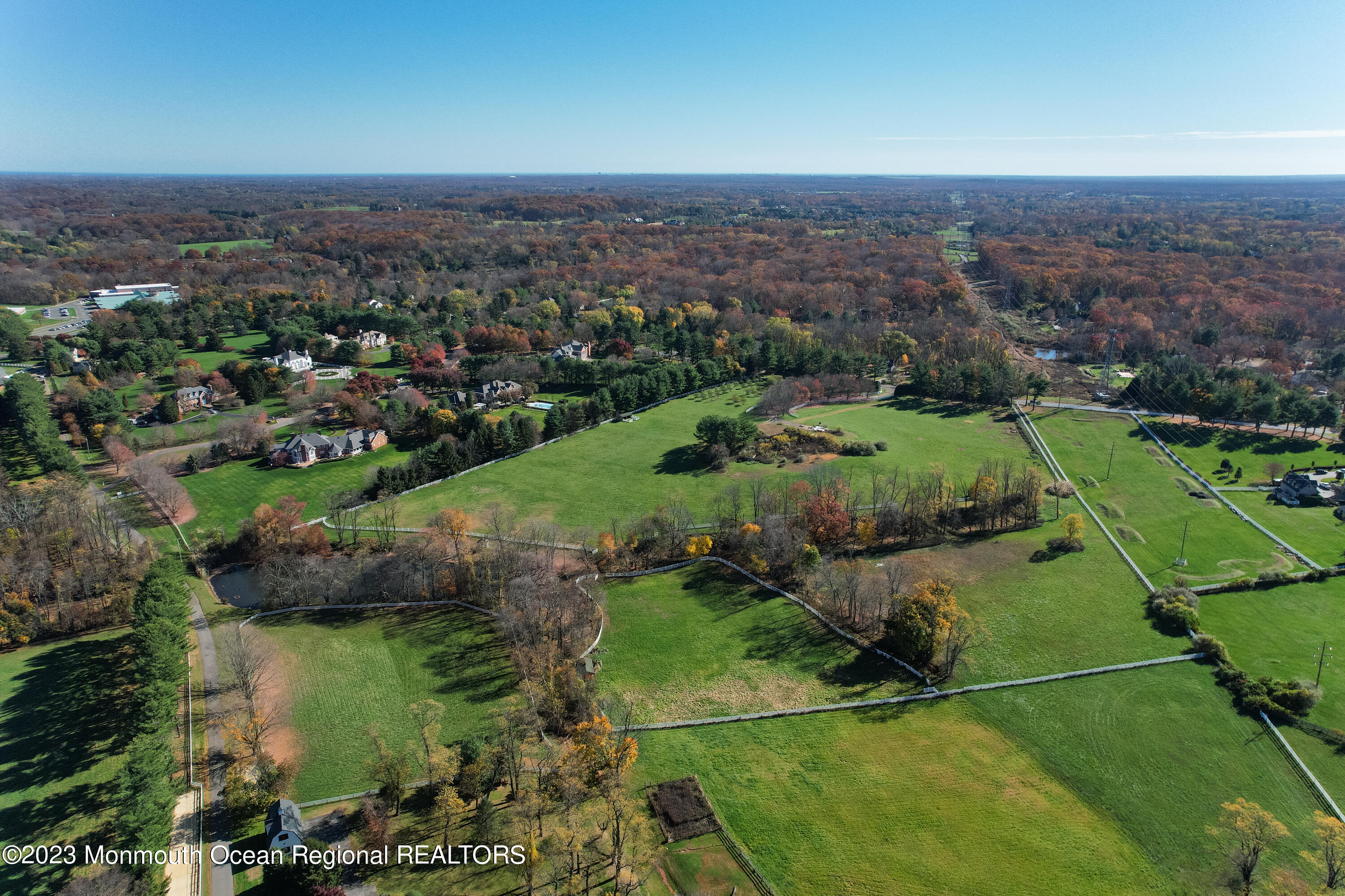 55 Crine Road Colts Neck, NJ 07722 - Photo 20 of 28 an aerial view of green landscape with trees houses and lake view