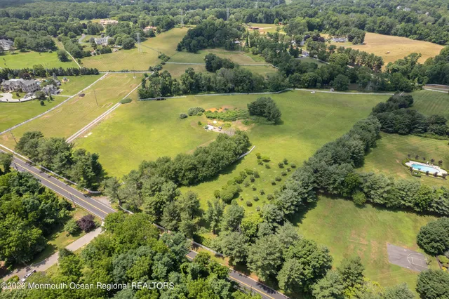 an aerial view of ocean residential house with outdoor space and trees all around