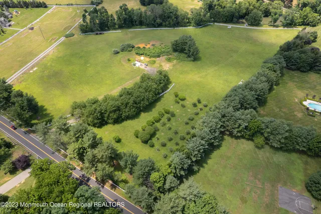 an aerial view of residential houses with outdoor space and swimming pool