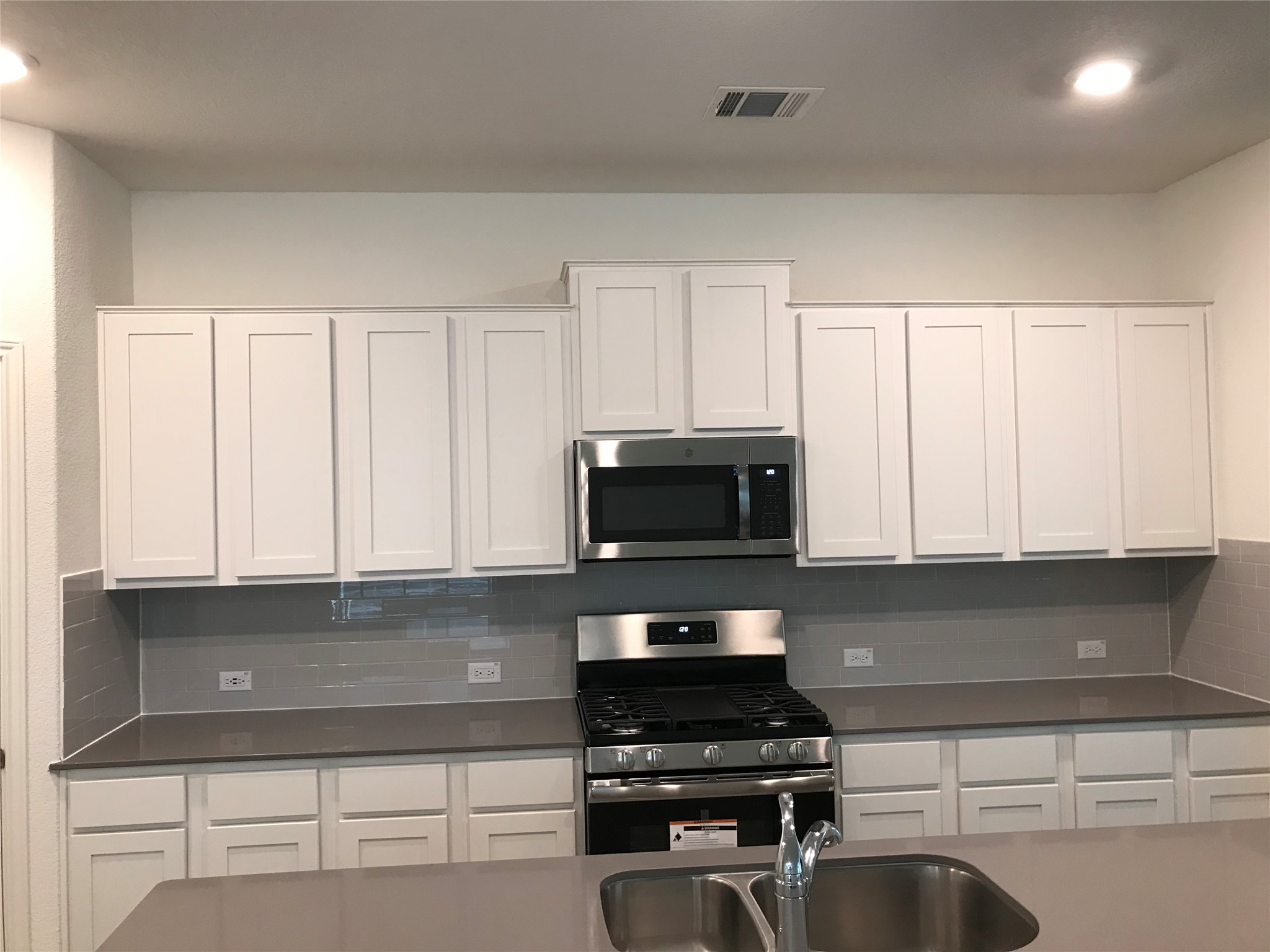 1200 Nokota Bend Georgetown, TX 78626 - Photo 13 of 39 a kitchen with granite countertop white cabinets and black appliances
