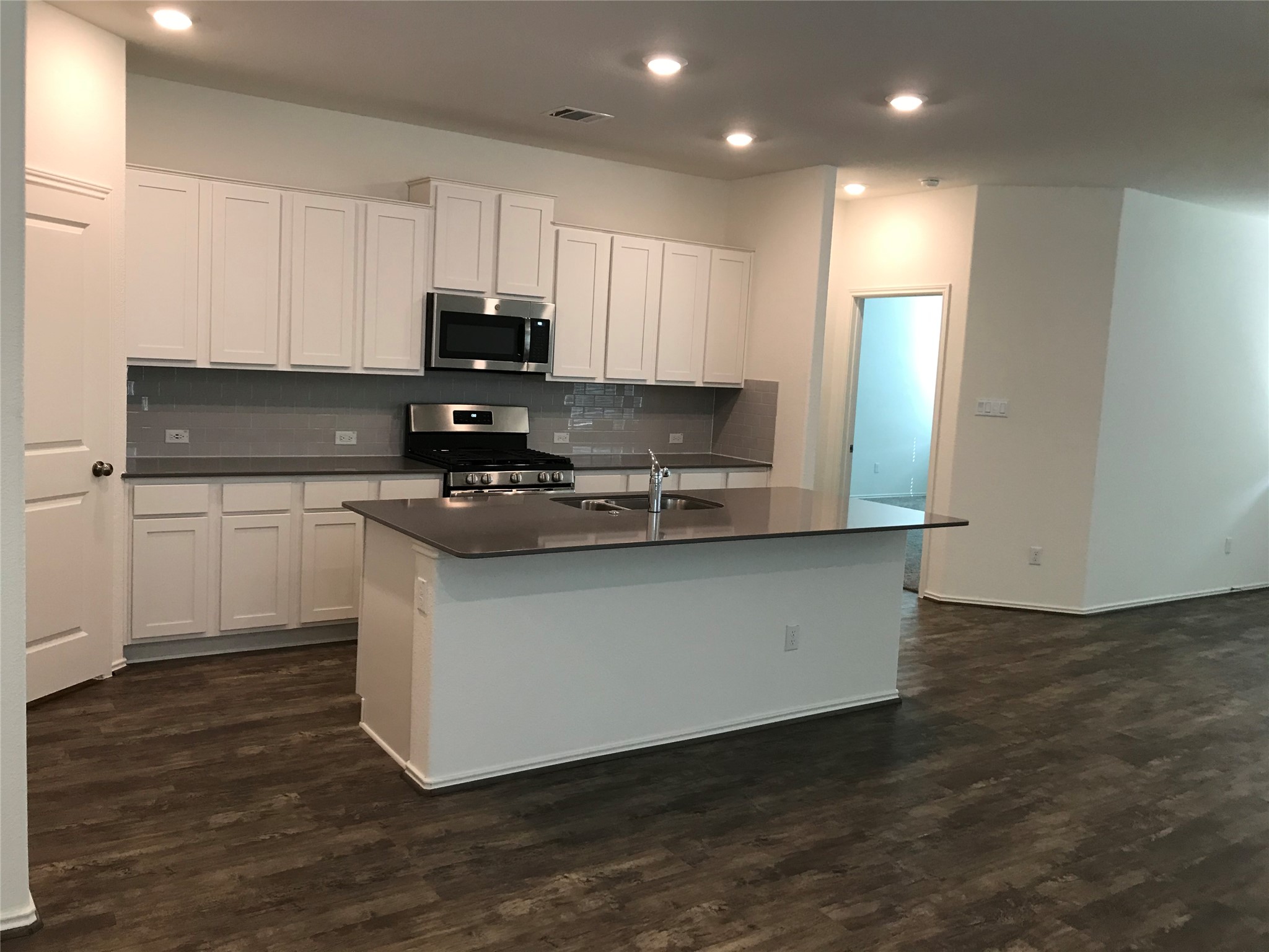 1200 Nokota Bend Georgetown, TX 78626 - Photo 33 of 39 a kitchen with stainless steel appliances granite countertop a stove a sink and a refrigerator