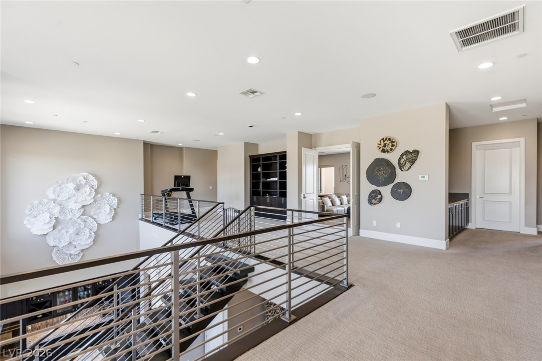 5 Crystal Tree Pass Henderson, NV 89052 - Photo 27 of 67 A spacious landing offers ample room for recreation or a home office setup, with modern railing.