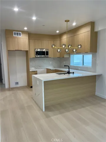 a view of kitchen with refrigerator and window