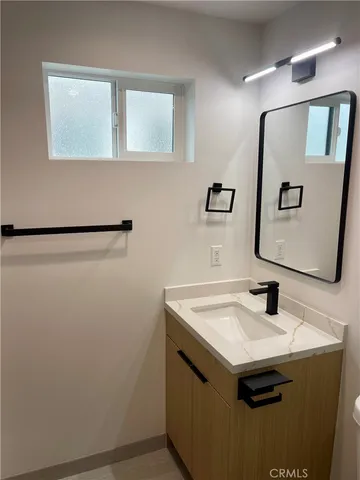 a bathroom with a shower and a glass door