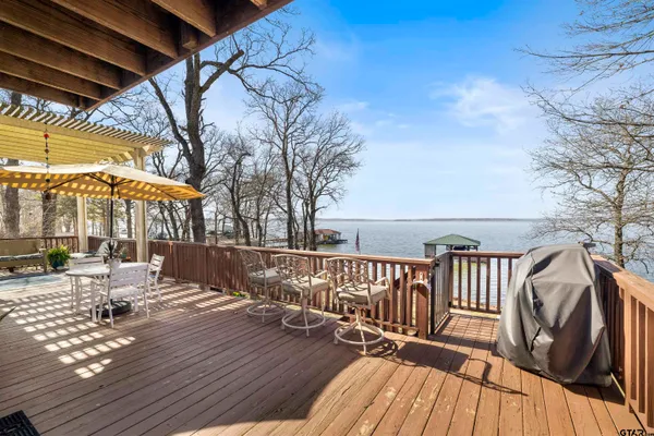 a large kitchen with a stove top oven a sink a counter space and cabinets