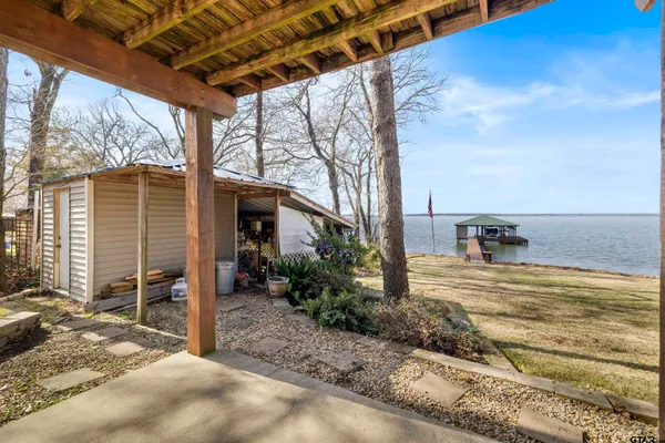 a kitchen with a sink stove and wooden floor