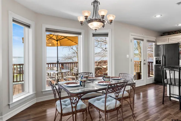 a bathroom with a double vanity sink mirror and toilet