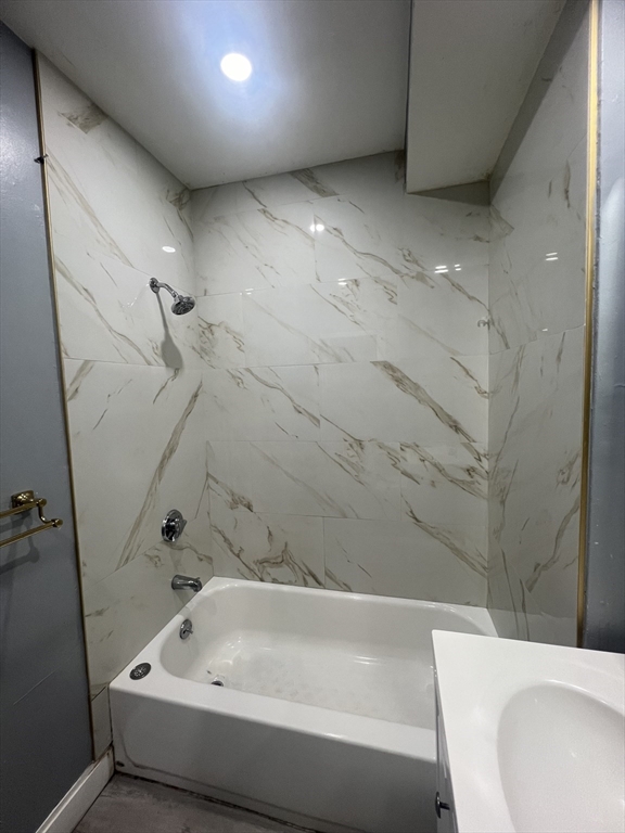 10 Essex Street, Unit 1 Brockton, MA 02301 - Photo 3 of 10 a bathroom with a bathtub and shower