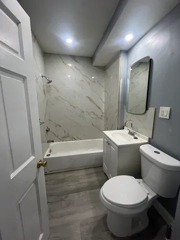 a bathroom with a toilet sink and bathtub