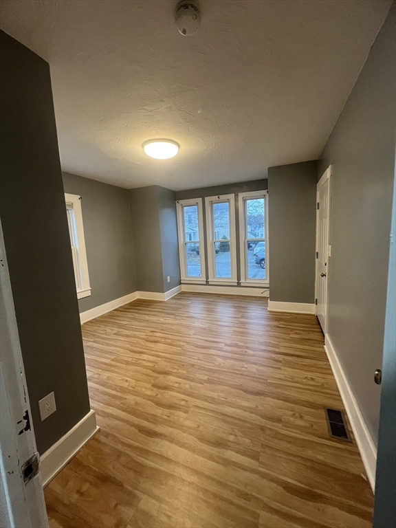 10 Essex Street, Unit 1 Brockton, MA 02301 - Photo 5 of 10 wooden floor in an empty room with a window