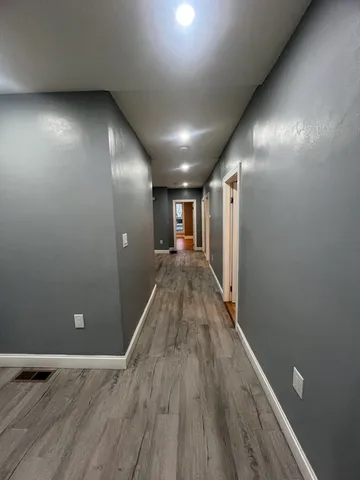 a view of hallway with wooden floor