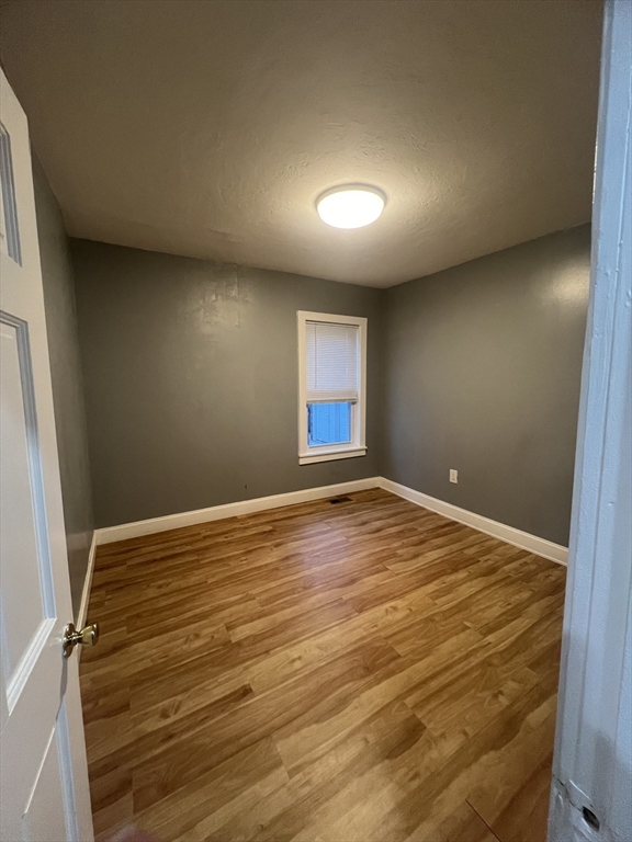 10 Essex Street, Unit 1 Brockton, MA 02301 - Photo 7 of 10 a view of empty room with wooden floor