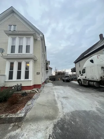 a view of a car park in front of a house
