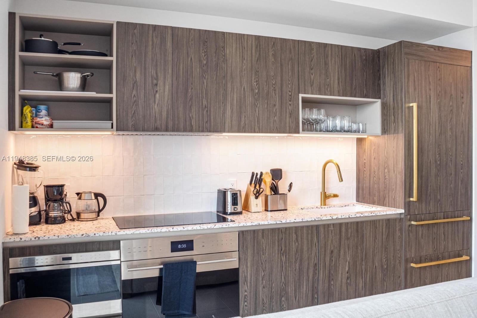 159 Northeast 6th Street, Unit 5101 Miami, FL 33132 - Photo 30 of 47 a kitchen with cabinets and window