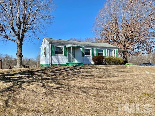 871 Halifax Road Roxboro, NC 27573 - Photo 1 of 45 a front view of a house with a garden