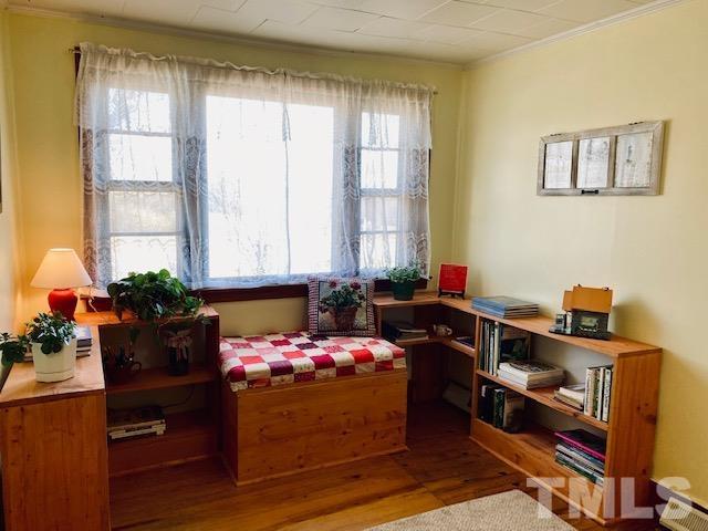871 Halifax Road Roxboro, NC 27573 - Photo 11 of 45 a bedroom with a bed and a potted plant