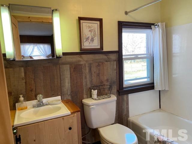 871 Halifax Road Roxboro, NC 27573 - Photo 14 of 45 a bathroom with a toilet sink and mirror