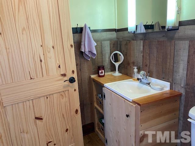 871 Halifax Road Roxboro, NC 27573 - Photo 15 of 45 a bathroom with a sink vanity and a mirror