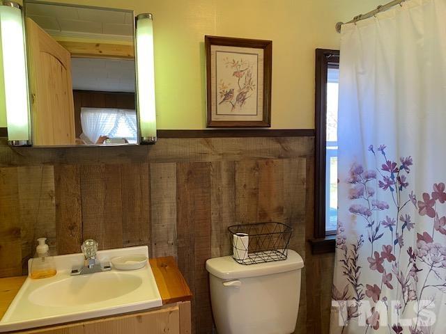 871 Halifax Road Roxboro, NC 27573 - Photo 16 of 45 a bathroom with a sink toilet and mirror