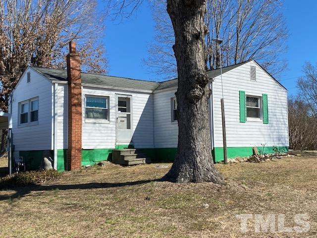 871 Halifax Road Roxboro, NC 27573 - Photo 2 of 45 a front view of a house with a yard and garage