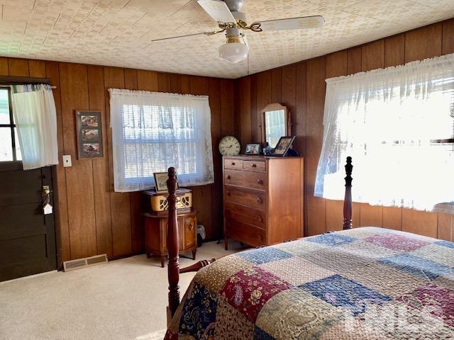 871 Halifax Road Roxboro, NC 27573 - Photo 22 of 45 a bedroom with a bed and wooden floor