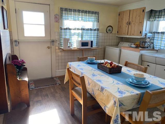 871 Halifax Road Roxboro, NC 27573 - Photo 26 of 45 a kitchen with stainless steel appliances granite countertop a stove a refrigerator a sink a dining table and chairs with wooden floor