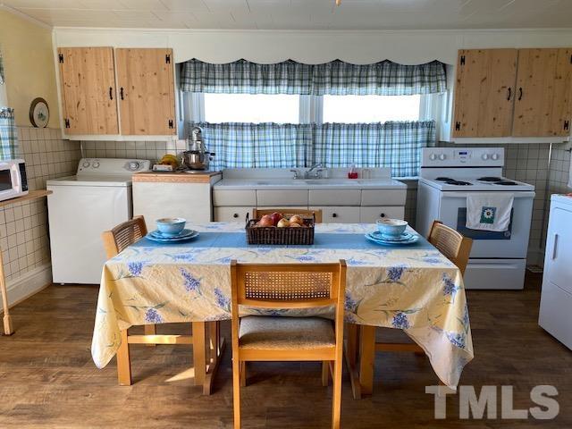 871 Halifax Road Roxboro, NC 27573 - Photo 27 of 45 a kitchen with a table chairs and a stove