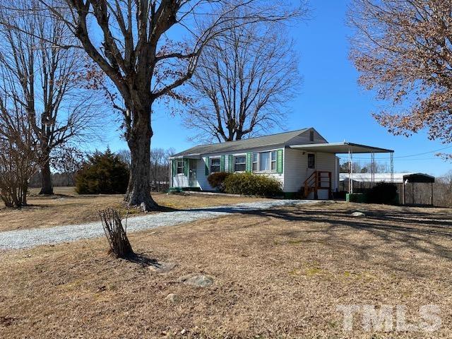 871 Halifax Road Roxboro, NC 27573 - Photo 32 of 45 a front view of a house with a yard and garage