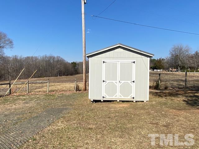 871 Halifax Road Roxboro, NC 27573 - Photo 5 of 45 a view of a barn in the middle of a yard