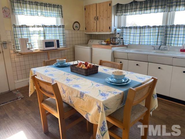 871 Halifax Road Roxboro, NC 27573 - Photo 7 of 45 a kitchen with a wooden table and chairs