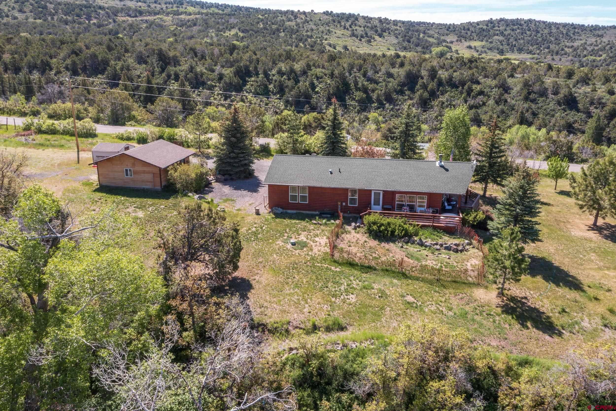 20751 Surface Creek Road Cedaredge, CO 81413 - Photo 3 of 35 an aerial view of a house with yard and green space