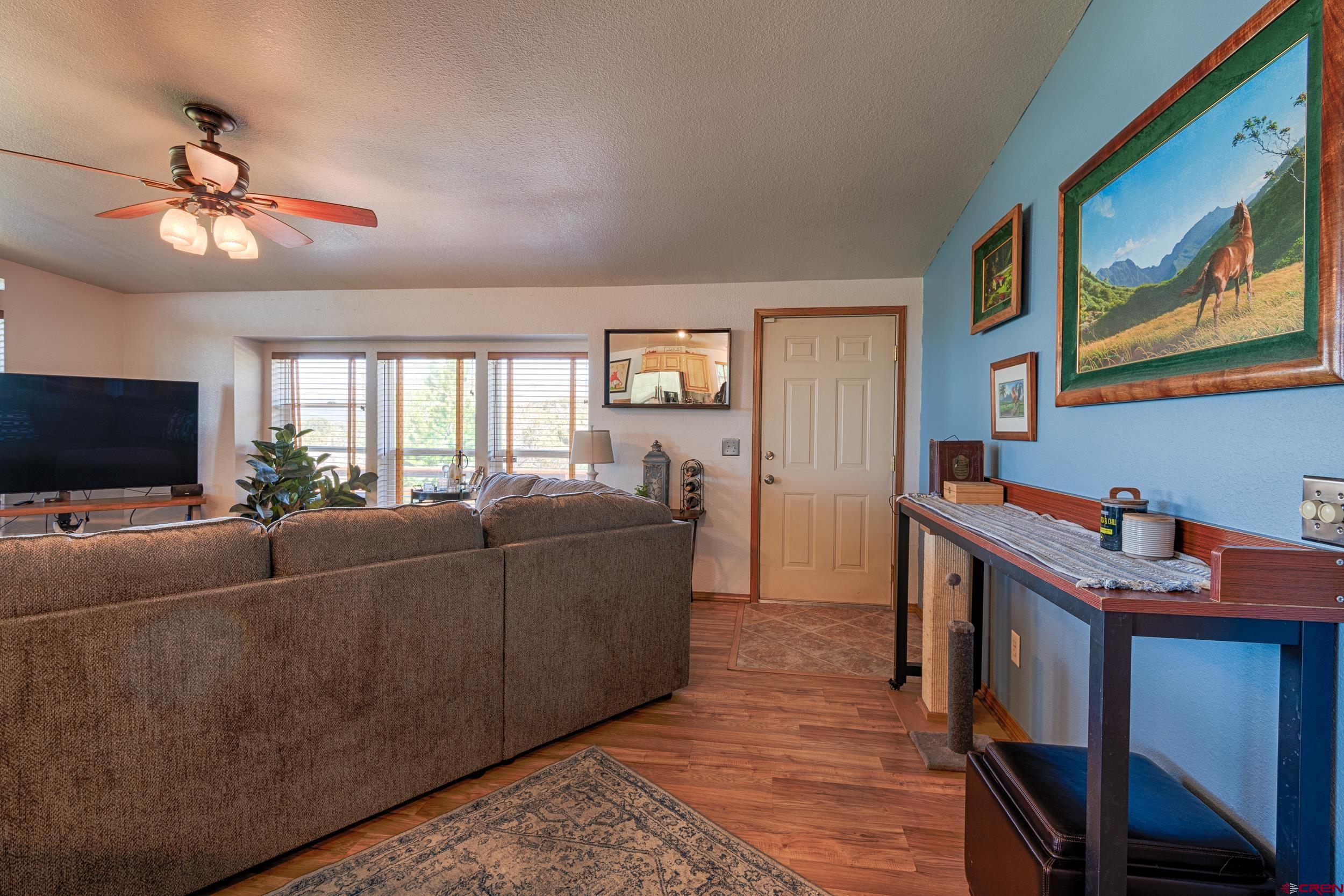 20751 Surface Creek Road Cedaredge, CO 81413 - Photo 6 of 35 a living room with furniture and a flat screen tv