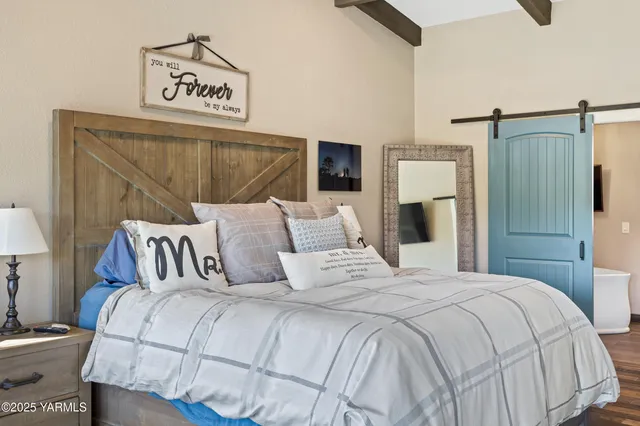 a bedroom with a bed and a night stand