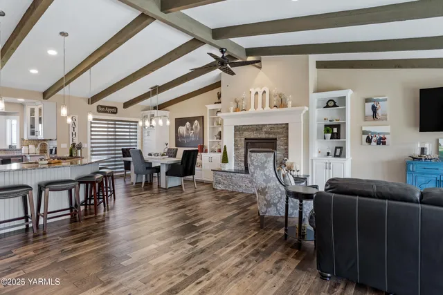 a living room with furniture a fireplace and a table