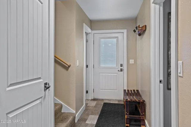 a view of a hallway with closet and a couch